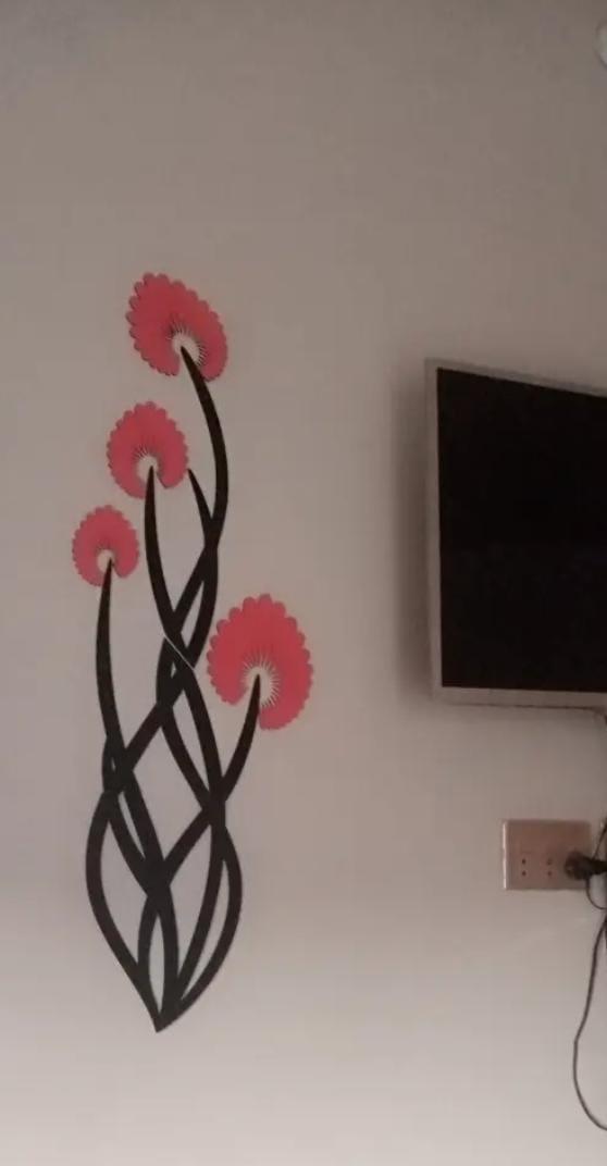 3D wooden flower wall art with orange petals and black stems